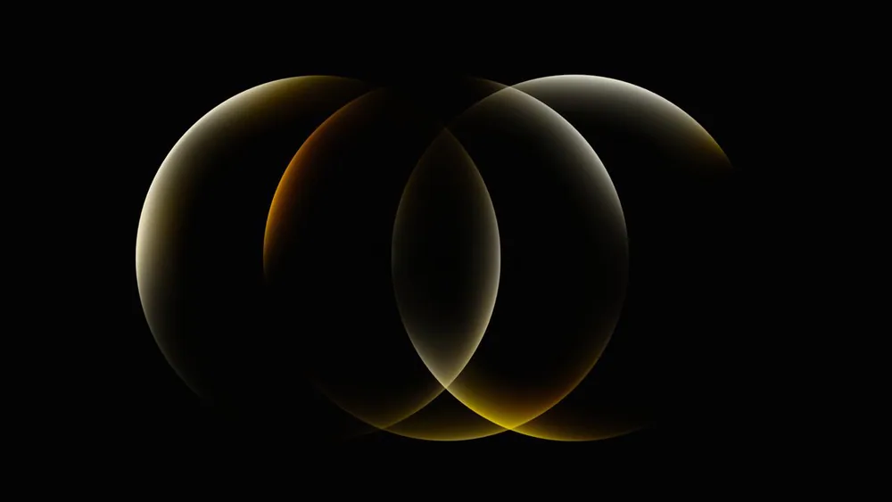 Two overlapping glowing rings on black, lit in gold and amber